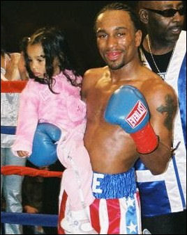 Jermaine "Too Sweet" White, holding his daughter after a victory.